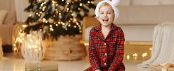 Girl sitting on the floor with a gift in a box