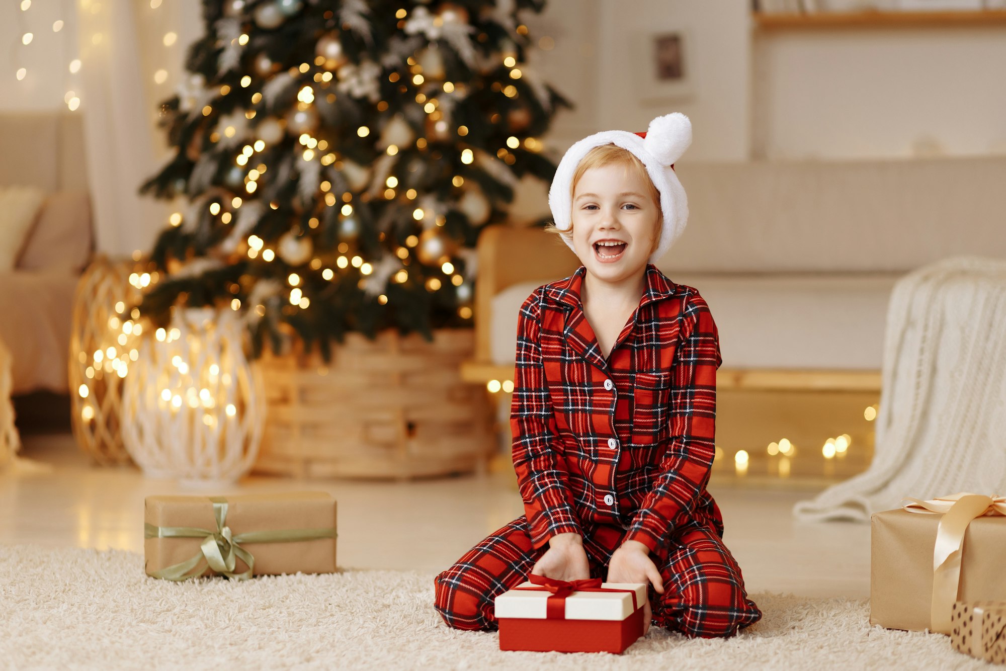 Girl sitting on the floor with a gift in a box