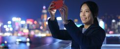 Woman take photo on cellphone at night