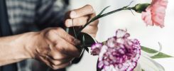 Young male florist working in flower shop